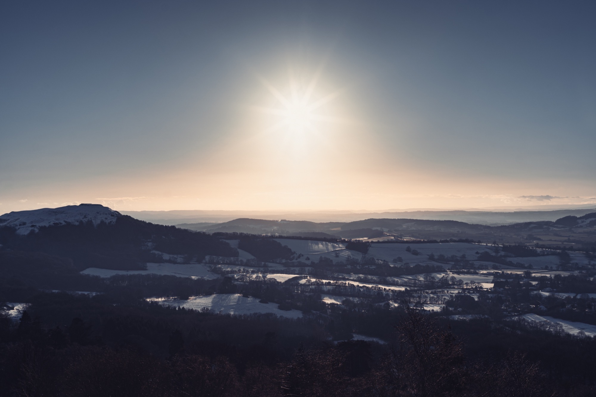 Landscape photography - snowy countryside sunburst