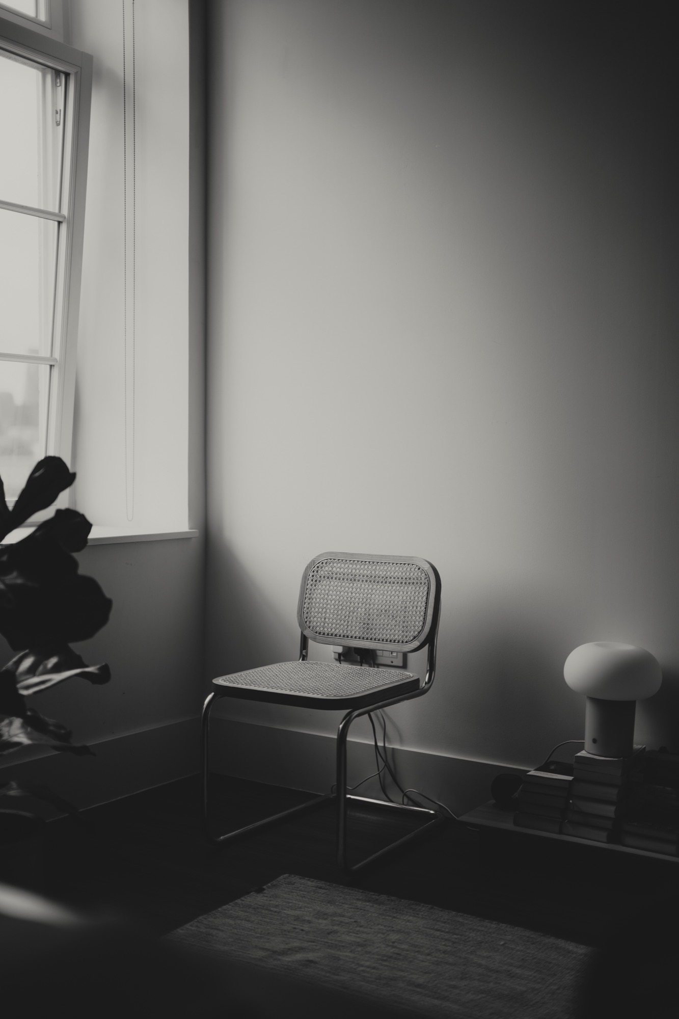 Portrait photography - woman on Cesca chair by window B&W