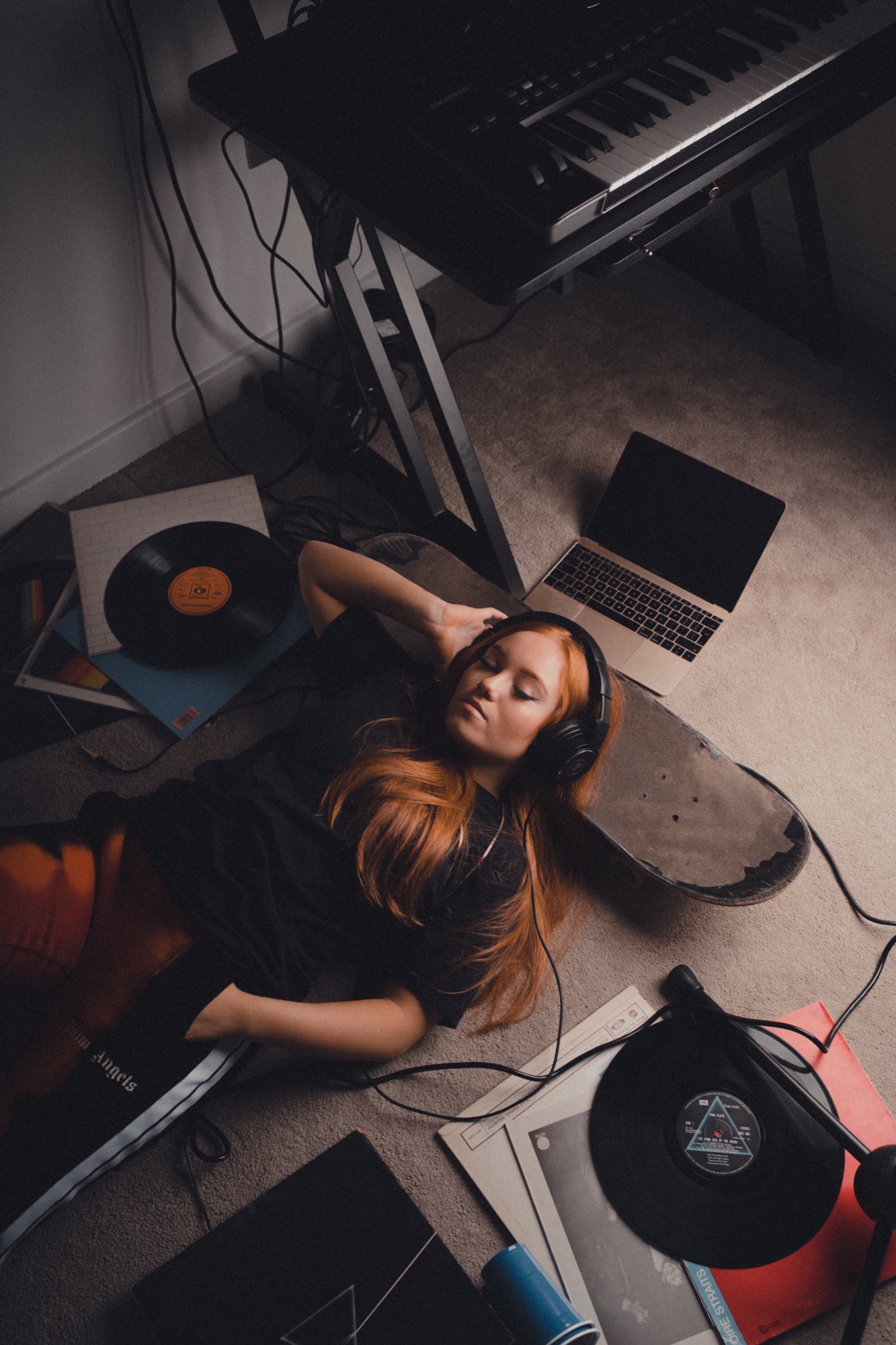 Portrait photography - red-haired woman with vinyl records