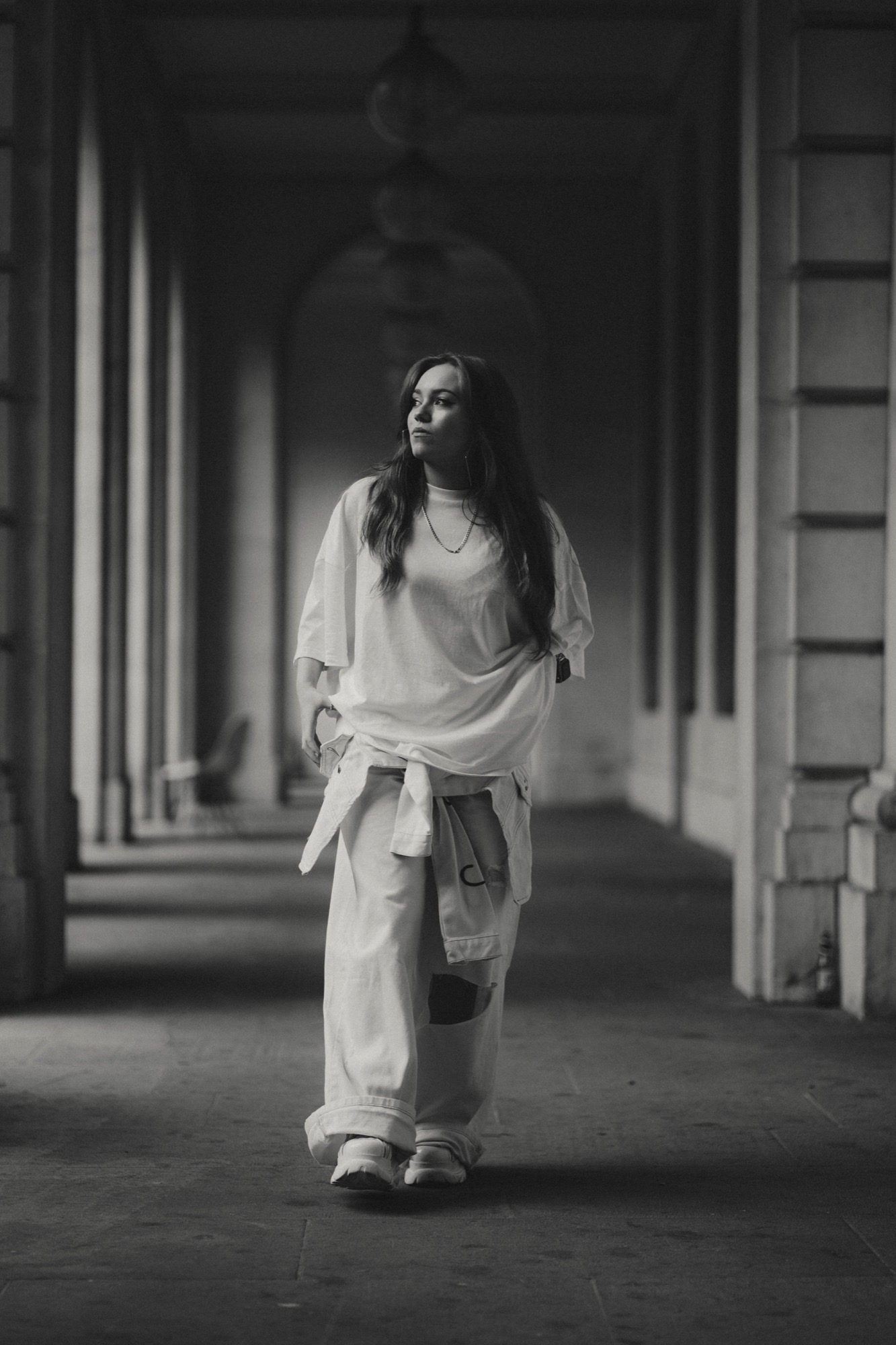 Portrait photography - woman in white colonnade